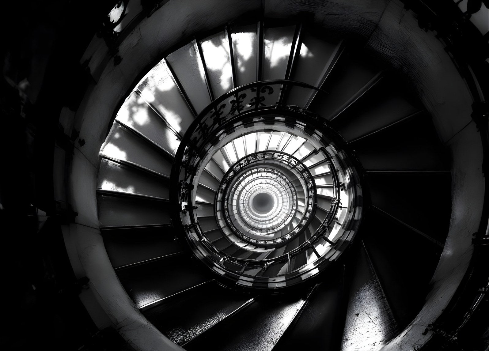 Vue en spirale d’un escalier architectural en photographie noir et blanc

